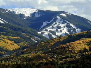 A mountainous landscape with snow-capped peaks and autumn-colored trees. - BC/Avon Mtn Gem-3BR/Pool/Hot Tub/Ski Shuttle/Sauna/Gondola Walk! (Avon)