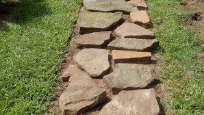 A stone pathway leading to a house with a number 1374 on the door. - Clean and Cozy Creekside Home (Conroe)