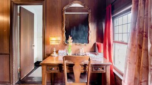 A room with a wooden desk, a mirror, a lamp, and a window with curtains. - A beautiful historic property in Downtown Detroit on the river side! Welcome FC! (Detroit)