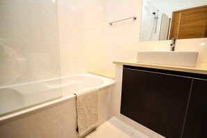 Bathtub, hair dryer, bidet, towels