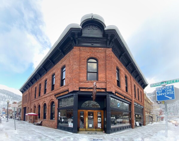 A historic brick building with large windows and a prominent entrance.