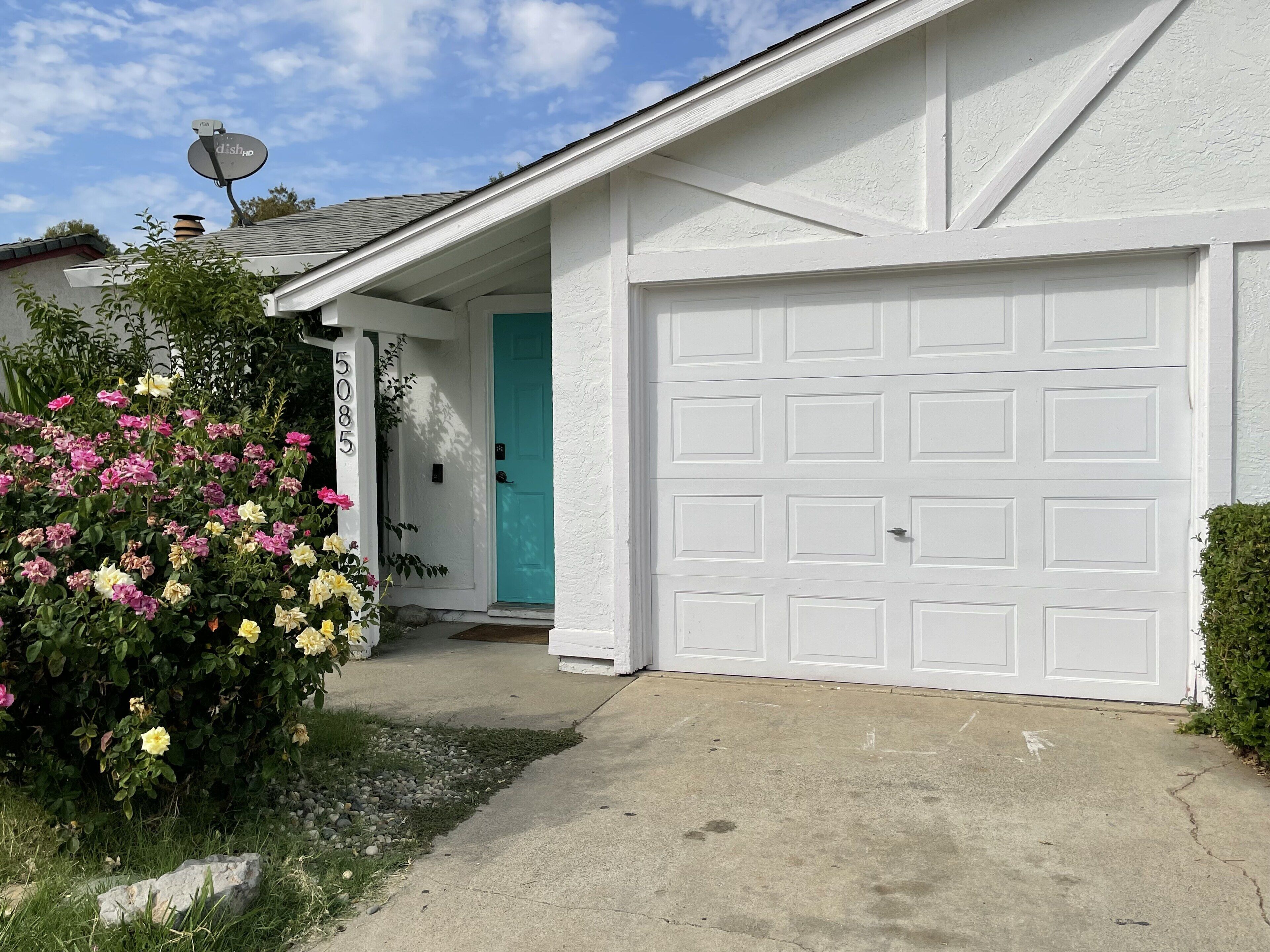 A residential garage with a white door and a mailbox.