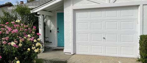 A residential garage with a white door and a mailbox.