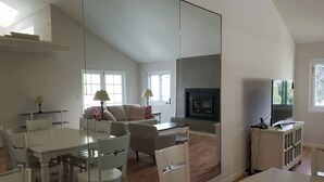 A spacious living area with a dining table, chairs, a sofa, and a fireplace. - Amazing Monthly Rental-Seascape Neighborhood! (Aptos)
