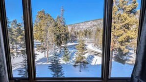 A window with a view of a snowy landscape with trees and a road. - Decatur 1806 (Keystone)