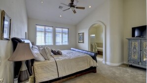 A bedroom with a bed, a ceiling fan, a television, and a cabinet. - Carlsbad Village, Great Beach Access, Shops & Restaurants (Carlsbad)