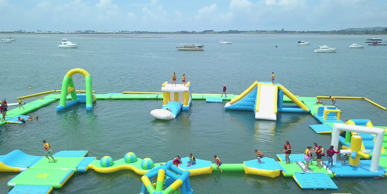 An inflatable water park with various play structures and slides.