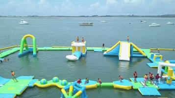 An inflatable water park with various play structures and slides.