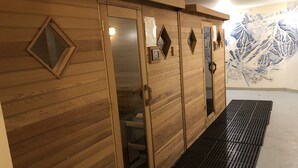 A row of wooden sliding doors with a mirrored section, a small framed picture, and a decorative mirror on the wall. - On ski resort mountain 2 bedroom 2 bathroom condo, access to hot tub and sauna (Fernie)