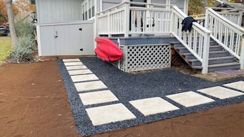 Enjoy the serene outdoor space with a wooden deck, stairs, and a shed, perfect for relaxation and recreation.