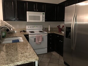 Microwave, coffee/tea maker, cookware/dishes/utensils