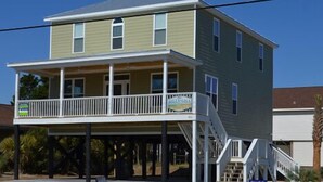 A two-story house with a balcony and a sign that reads "FAMILY LIVING". - Billy-Lisa - Second Row in Garden City Beach, SC (Garden City)