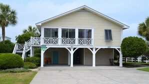 A two-story house with a balcony, a covered porch, and a number '1690' on the front. - Swamp Fox (Formerly Footprints) - Second Row in Garden City Beach, SC (Garden City)
