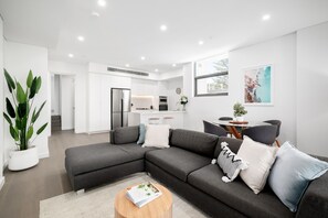 Two Bedroom Penthouse With Parking | Living area | 49-inch Smart TV with digital channels, TV