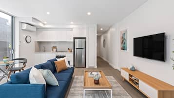 One Bedroom Apartment With Parking | Living area | 49-inch Smart TV with digital channels, TV