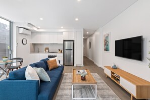 One Bedroom Apartment With Parking | Living area | 49-inch Smart TV with digital channels, TV
