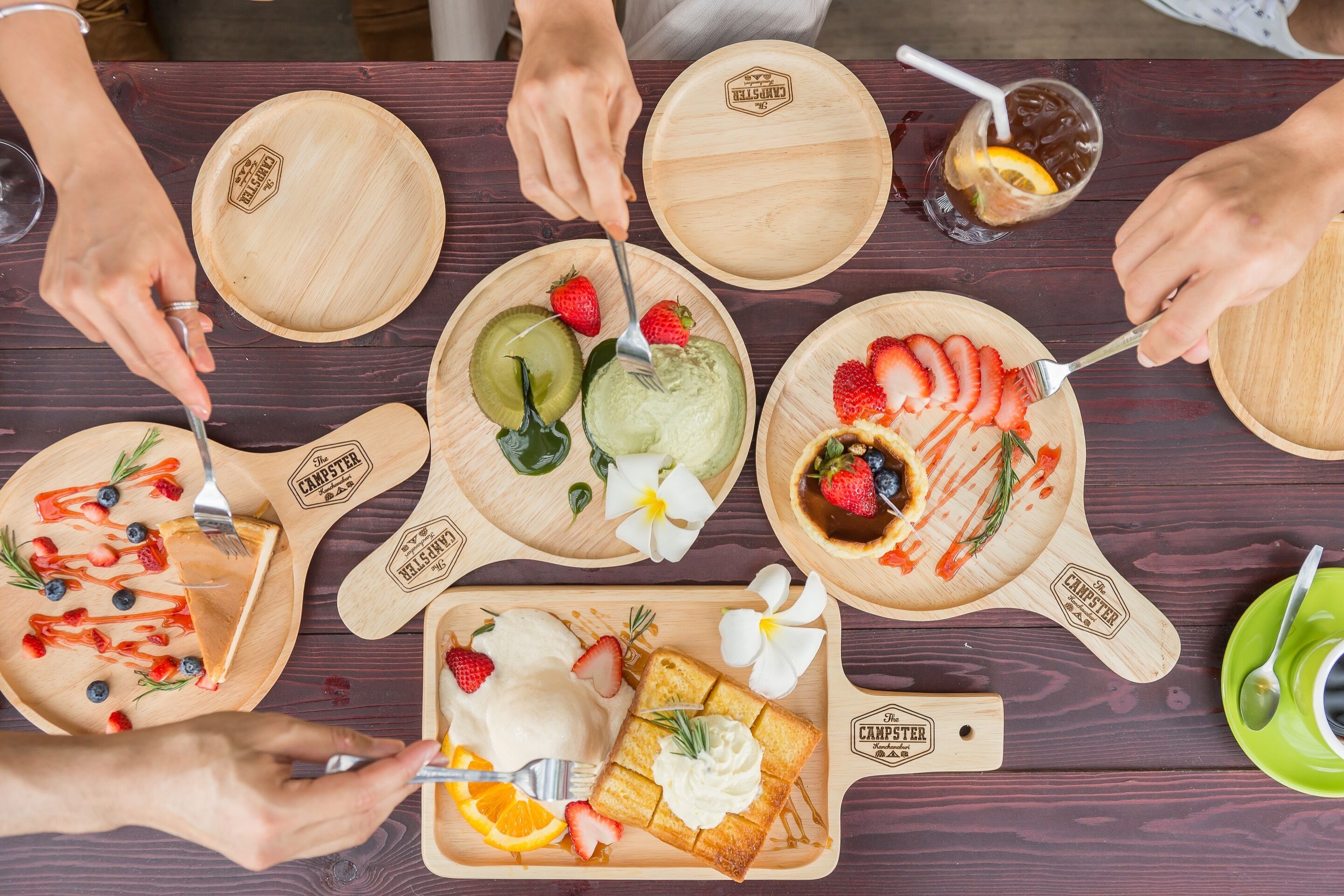 A wooden table with various food items and utensils.