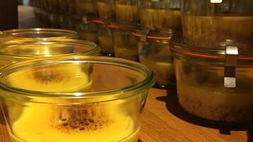 A row of glass jars with metal lids on a wooden surface.