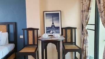 Basic Studio, Multiple Beds | Living area | 32-inch flat-screen TV with cable channels, TV