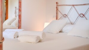 A bed with white linens and pillows, a wooden headboard, and a mirror reflecting part of the room. - Villa Joana with Mountain View, Wi-Fi, Garden, Pool & Terraces (Pollensa)