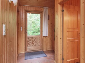 A wooden door with a window, a doorbell, and a mat at the entrance. - 6 Person Holiday Home in Gilleleje (Gilleleje)