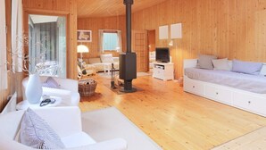 A cozy wooden interior with a sofa, a TV, a fireplace, and a dining area. - 6 Person Holiday Home in Gilleleje (Gilleleje)