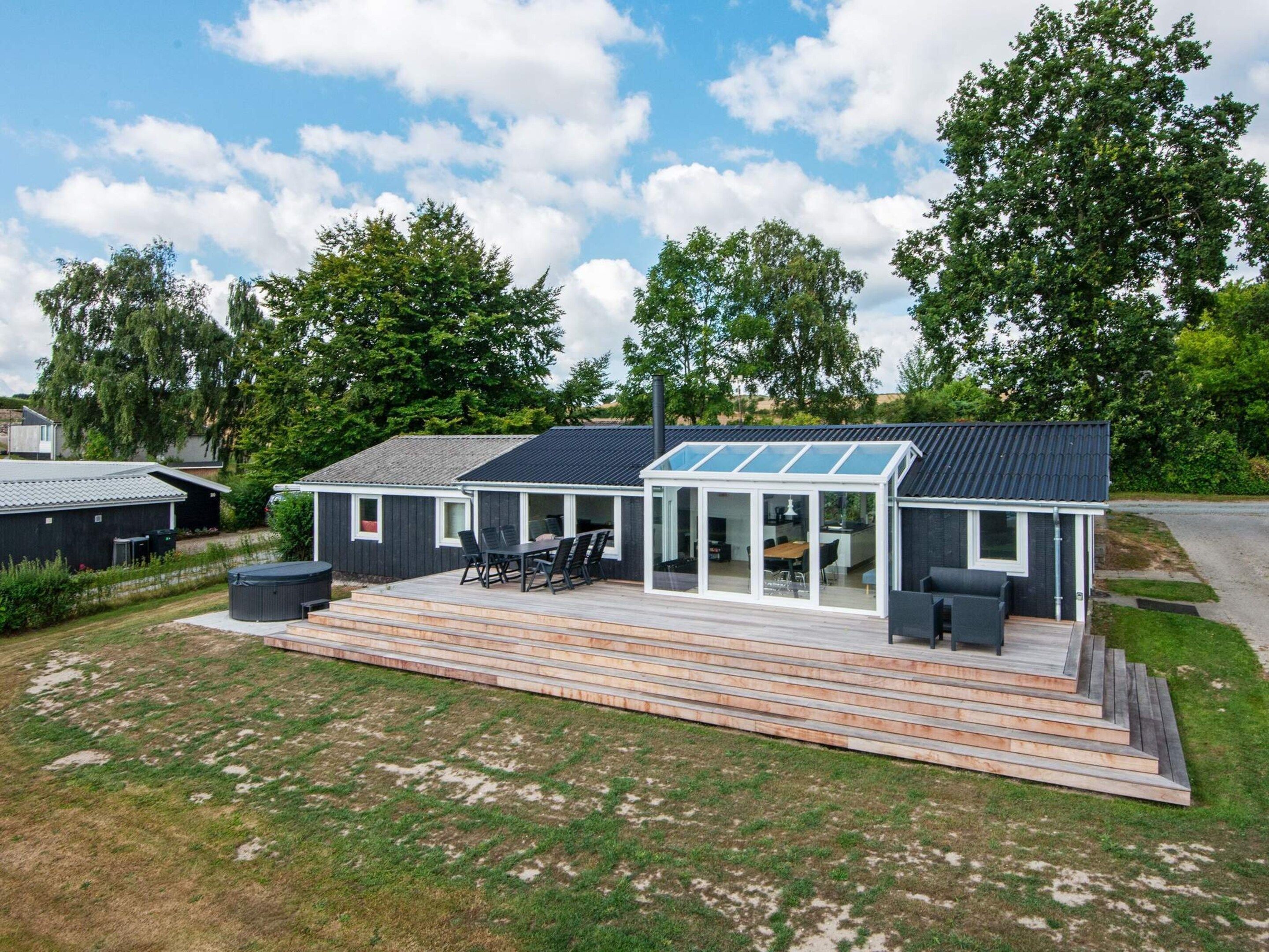 A modern house with a patio, a dining area, and a garage.