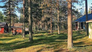 A rural setting with a dirt path, wooden structures, and tall trees. - 6 Person Holiday Home in Rorbacksnas (Lima)