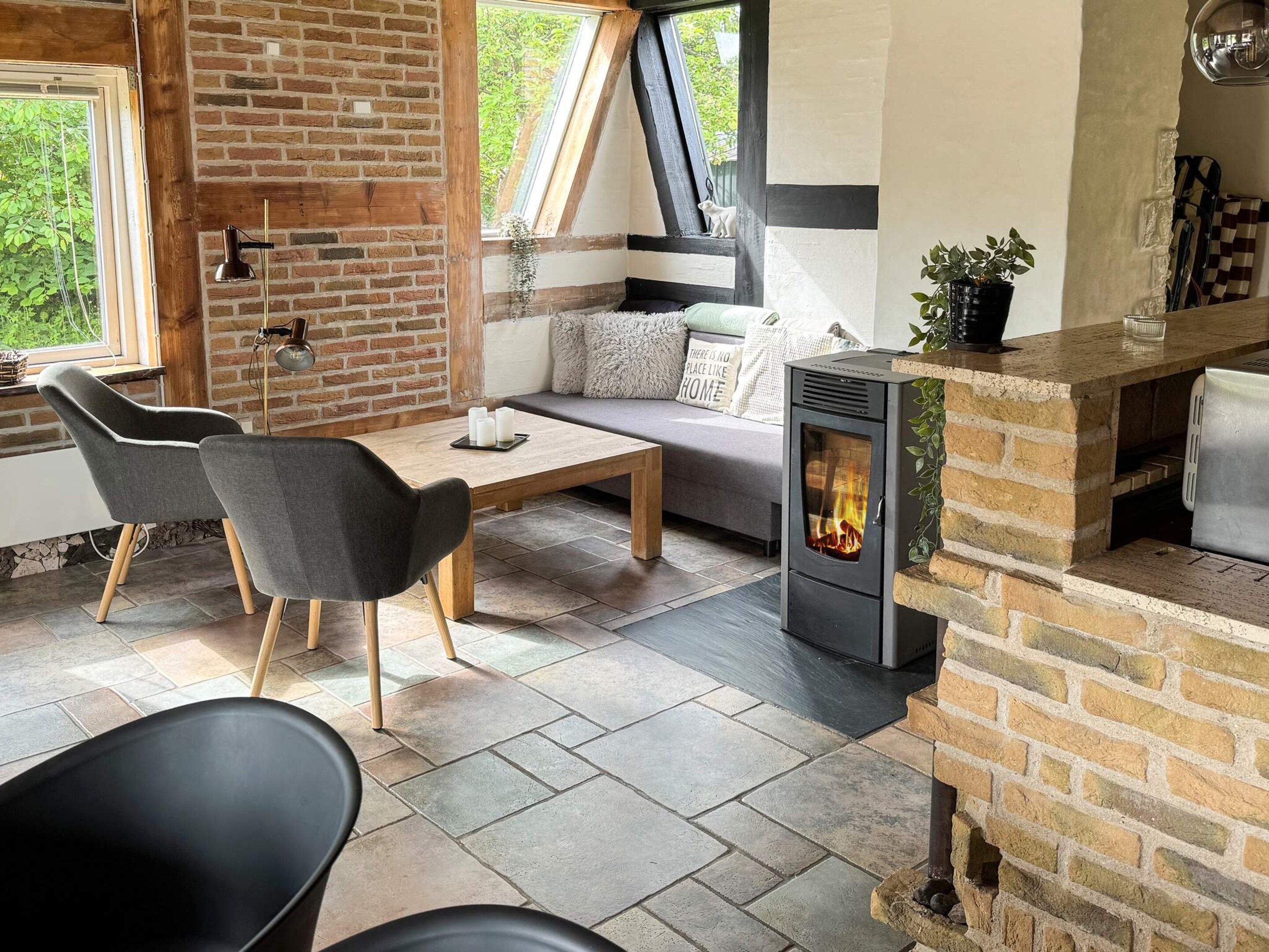 A cozy living area with a fireplace, a sofa, and a dining table.