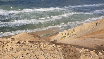 A rocky beach with waves crashing onto the shore.