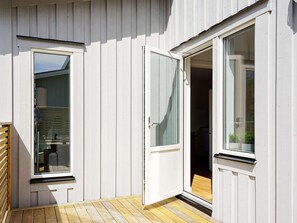A room with a wooden floor, a sliding door, and a window. - 4 Star Holiday Home in Stromstad (Stromstad)