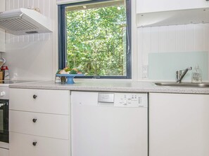 A kitchen with a window, a dishwasher, and a sink. - 5 Person Holiday Home in Grenaa (Grenaa)