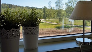 A window with two potted plants and a lamp on a windowsill. - 4 Person Holiday Home in Ucklum (Ucklum)
