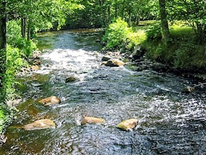 A river flowing through a forested area with rocks in the water. - 4 Person Holiday Home in Olofstrom (Olofström)