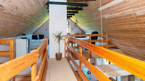 A narrow, wooden interior with bunk beds and a central column. - Holiday Home in Aars (Aars)