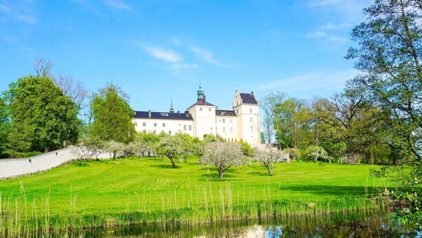 A large, white building with a symmetrical facade, a central tower, and a surrounding moat. - 4 Person Holiday Home in Tyreso (Tyreso)