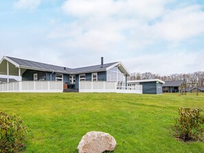 A two-story house with a covered porch and a separate garage.