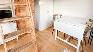A room with a wooden ladder, a white table, and a white wardrobe. - 4 Person Holiday Home in Fotö, Västra Götaland (Fotö)