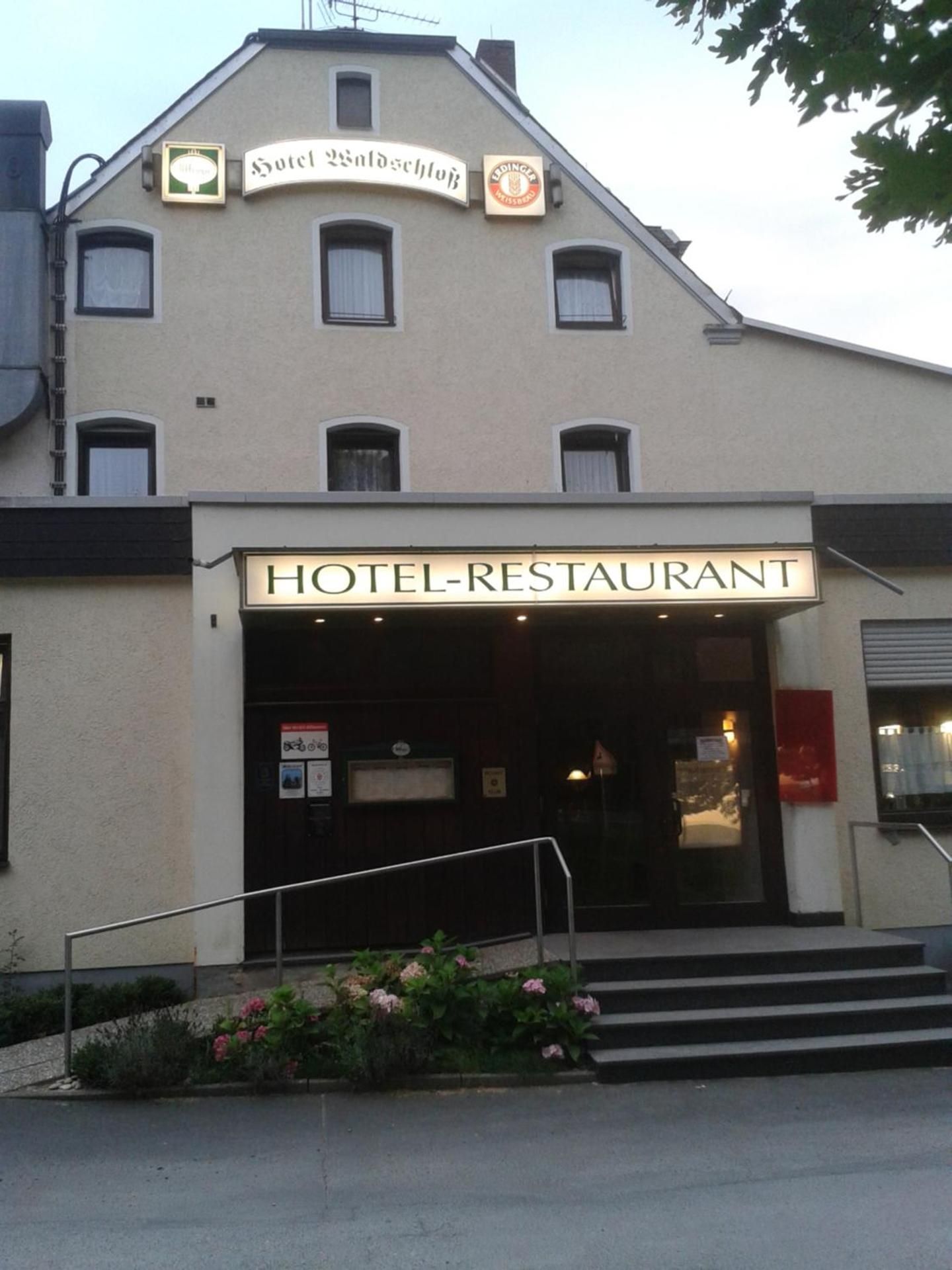 A hotel with a sign reading 'HOTEL RESTAURANT' above the entrance.