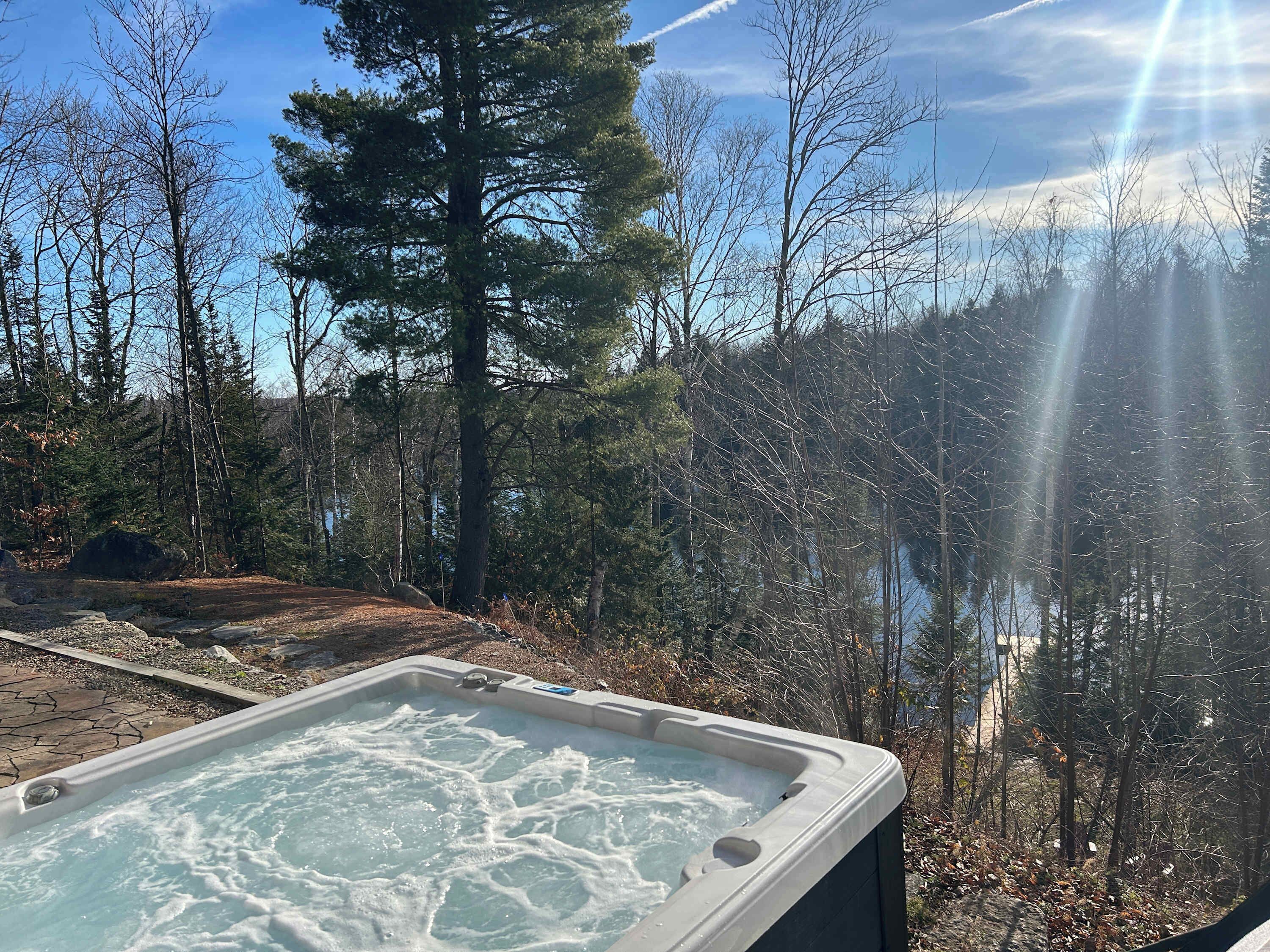 Relaxing view of a tranquil lake from a private hot tub.