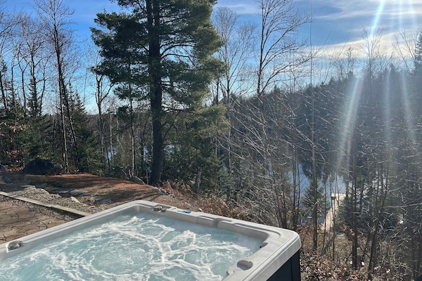 Relaxing view of a tranquil lake from a private hot tub.