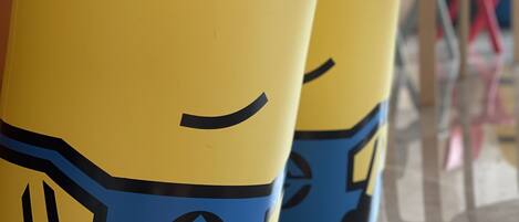 Two yellow and blue inflatable toys with Minion faces.