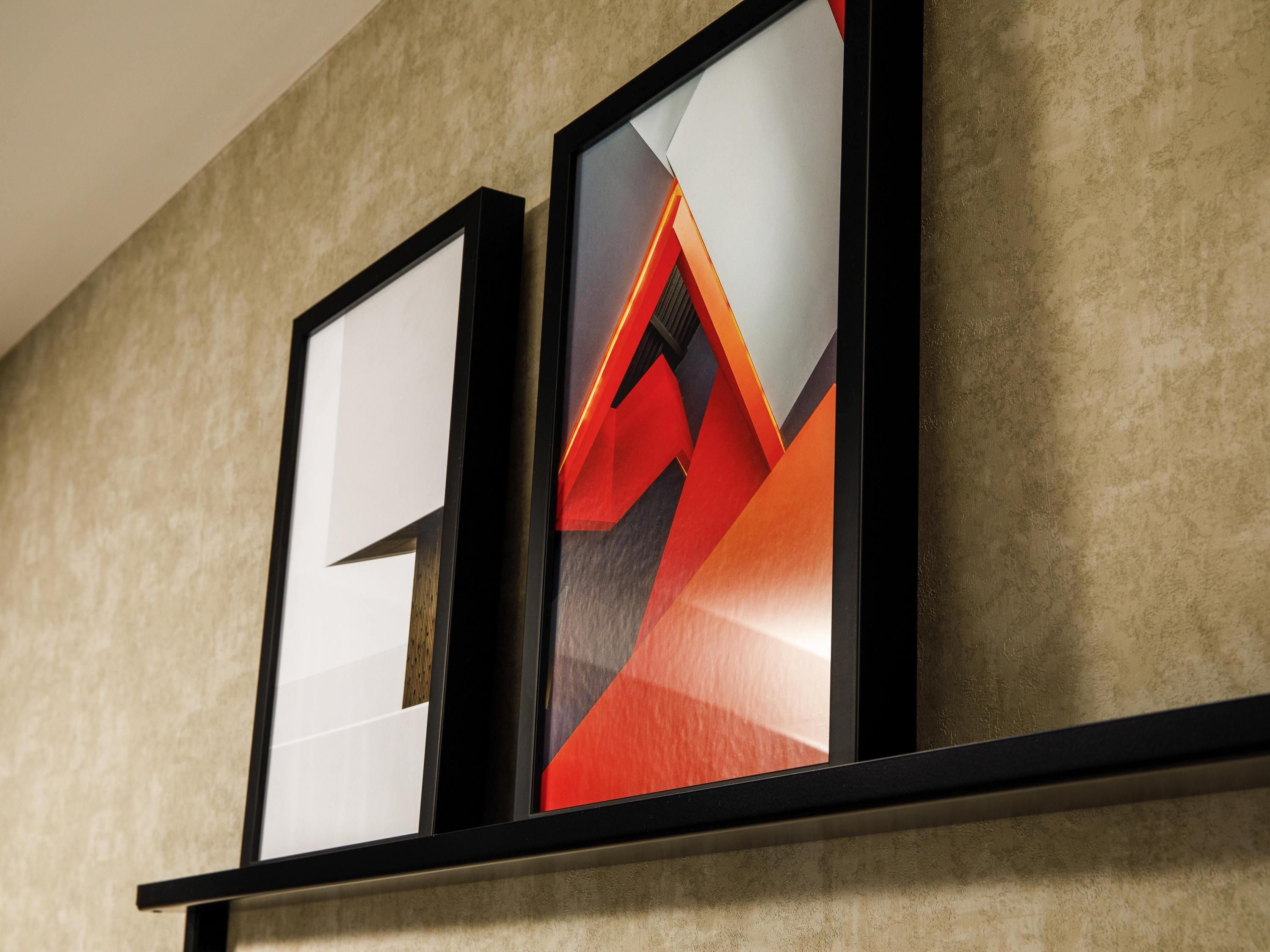 Two framed artworks on a wall.