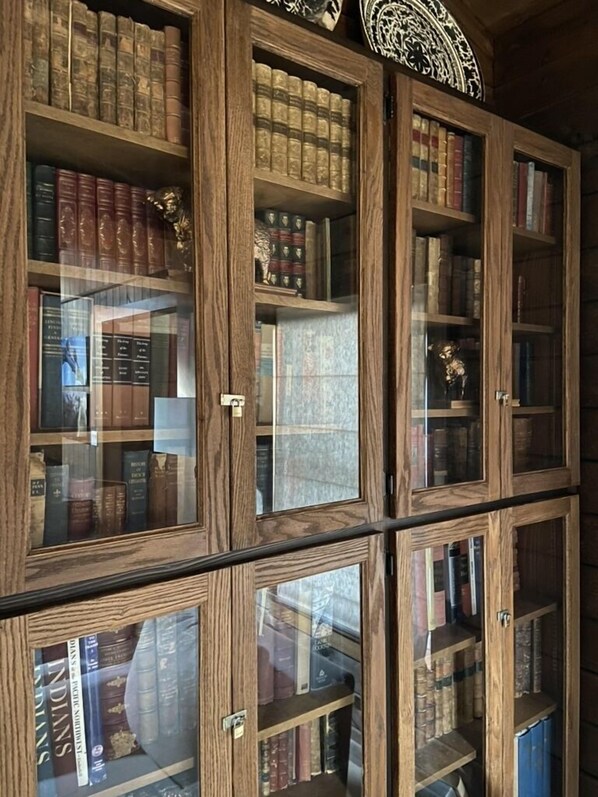 A wooden bookcase with multiple shelves filled with books. - The Orr House in Ennis (Ennis)