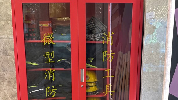 A red-framed glass door with yellow text and a fire extinguisher inside. - Mercure Xian City Centre (Xi'an)