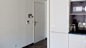 A modern kitchen with white cabinets and a stainless steel oven. - APARTEMENT CANNES CROISETTE 4th floor (CANNES)