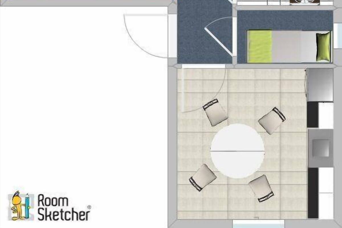 A hotel room layout with a bed, seating area, and kitchenette.