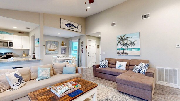 A spacious living area with a kitchen, a dining area, and a view of the ocean. - 2nd Floor, Pet Friendly, Close to Marina and Ferry, Golf Cart Access (Port Aransas)