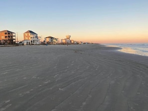 A beach with buildings in the background.