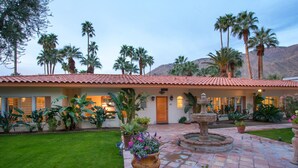 A house with a red-tiled roof, a well-maintained lawn, and a fountain in the center. - Maison du Soleil (Palm Springs)